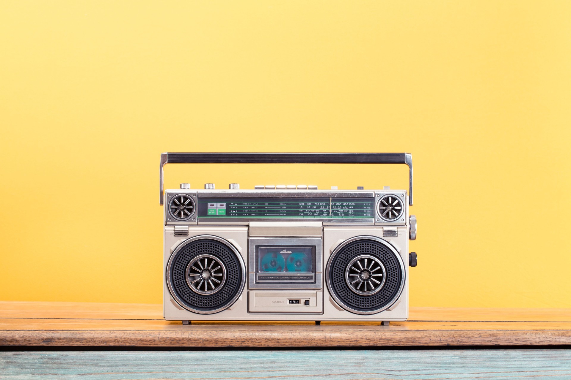 Retro boombox radio cassette recorder from circa 80s front yellow background. Vintage old style filtered photo Retro boombox radio cassette recorder from circa 80s front yellow background. Vintage old style filtered photo